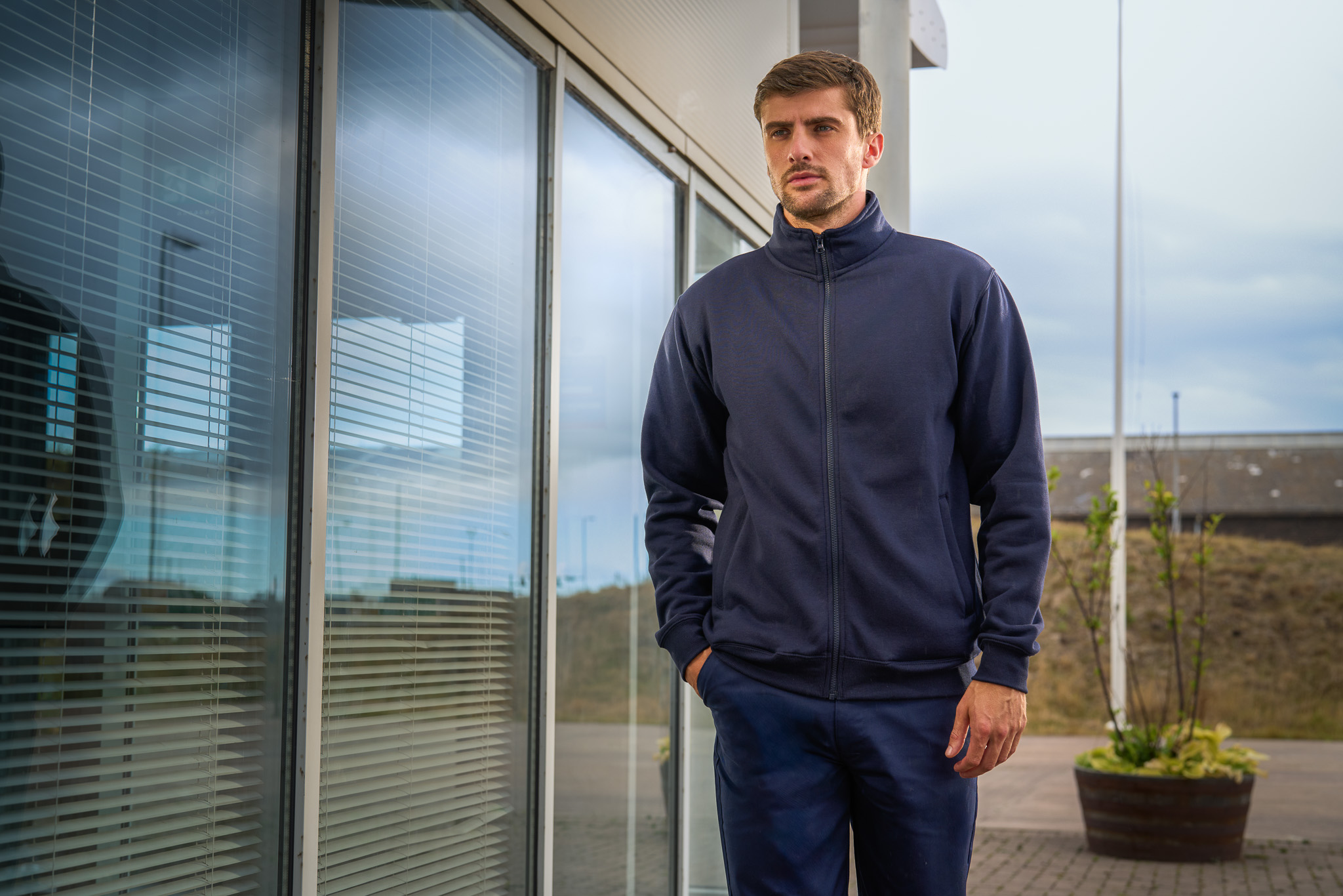 PRO RTX navy softshell jacket worn outside an office
